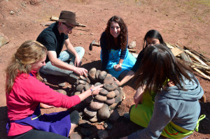 Step 2: Playing Jenga with rocks in an effort to make a structurally stable stone dome. 